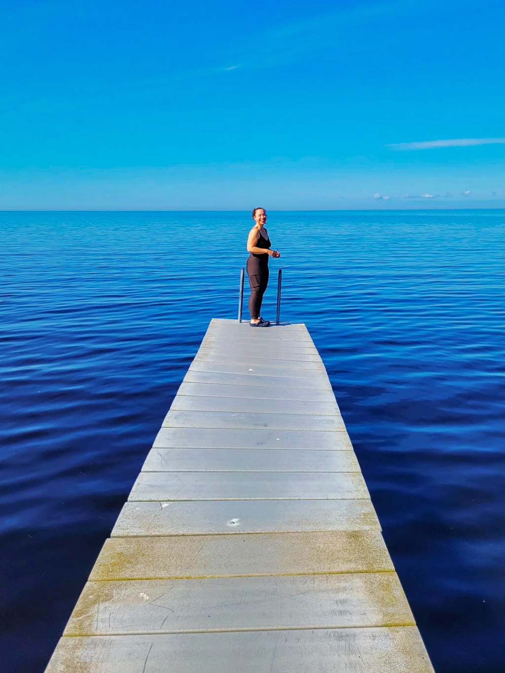 Pernilla längst ut på en lång brygga ut i Östersjön, vid Kleva strand.