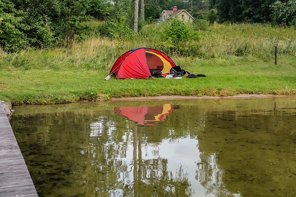 Mitt tält Hilleberg Niak uppsatt på grässtranden vid sjön Yxningen.