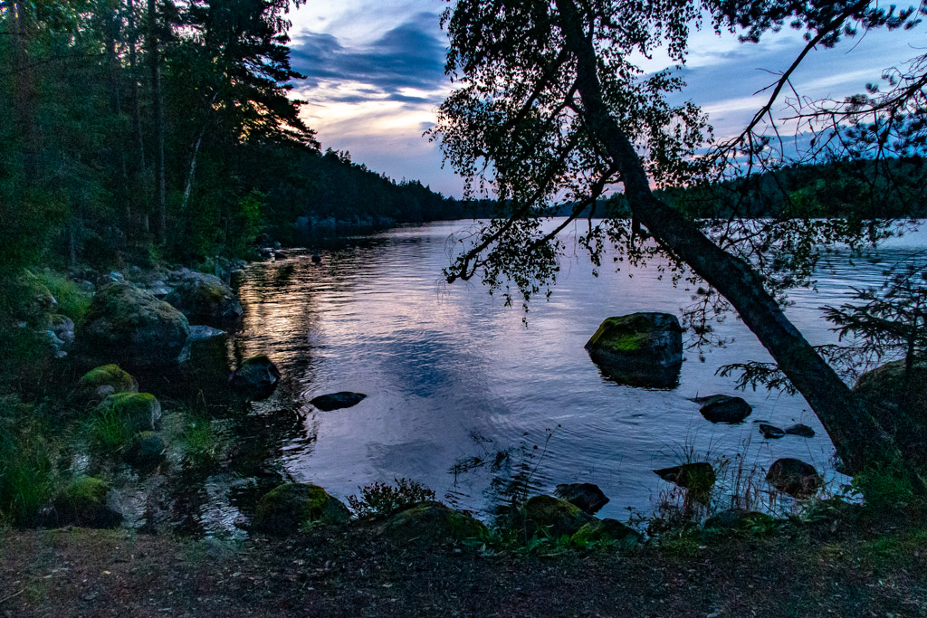 Vik in i Sommen färgas lila av solnedgången. 